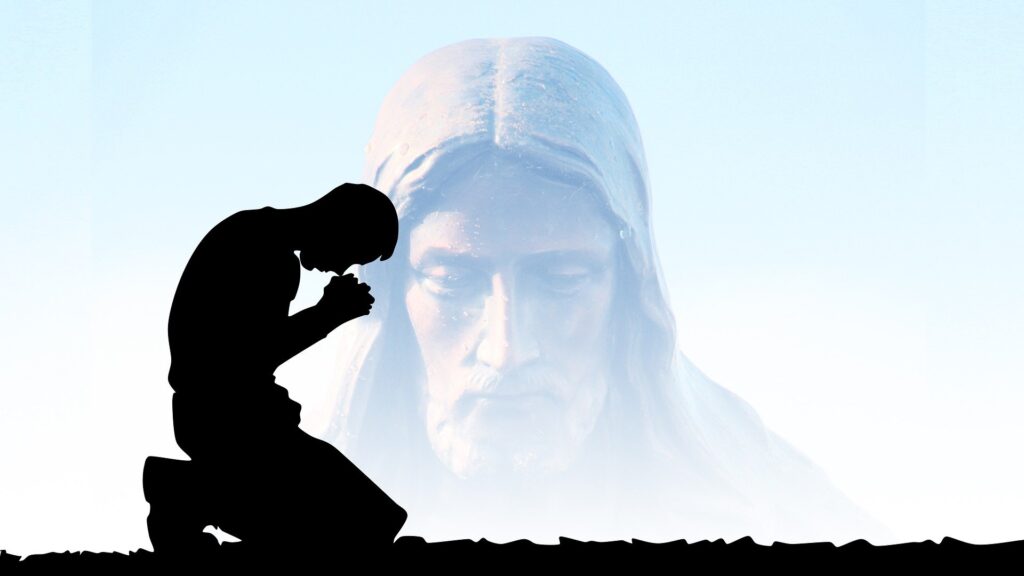 Silhouette of man praying in front of God